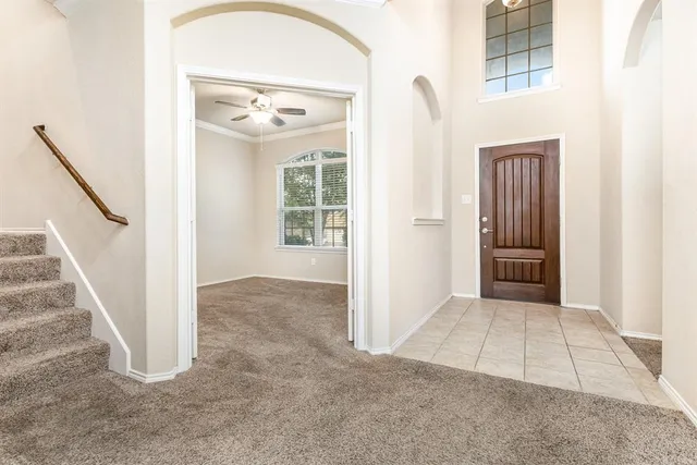 a view of an empty room with a window and fireplace