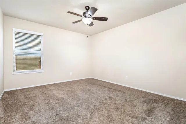 a spacious bedroom with a bed and a table in it