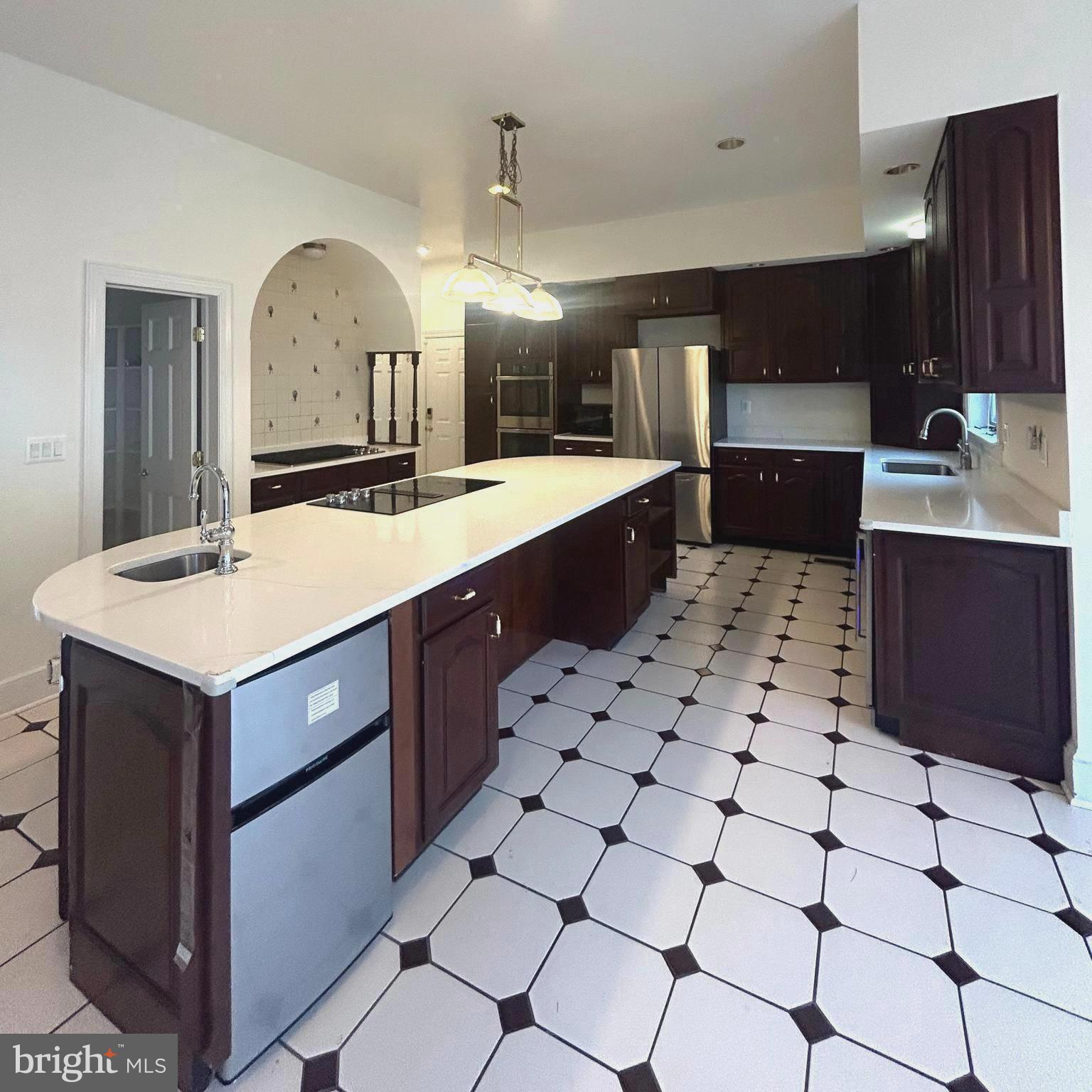 914 Helga Place McLean, VA 22102 - Photo 11 of 72 a large kitchen with kitchen island a sink stainless steel appliances and cabinets