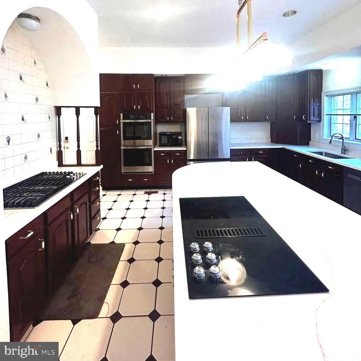 914 Helga Place McLean, VA 22102 - Photo 12 of 72 a kitchen with stainless steel appliances kitchen island granite countertop a refrigerator and a stove