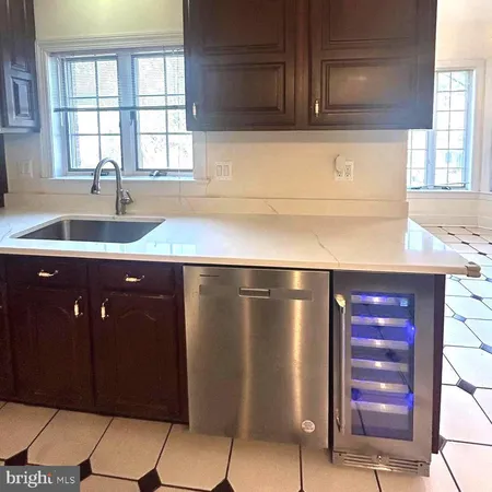 a room with a wooden cabinets and utility