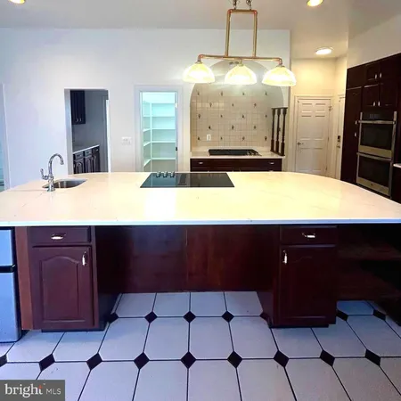 a kitchen with stainless steel appliances a sink stove and cabinets