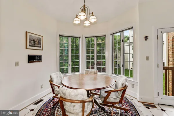 a view of a dining room with furniture and chandelier