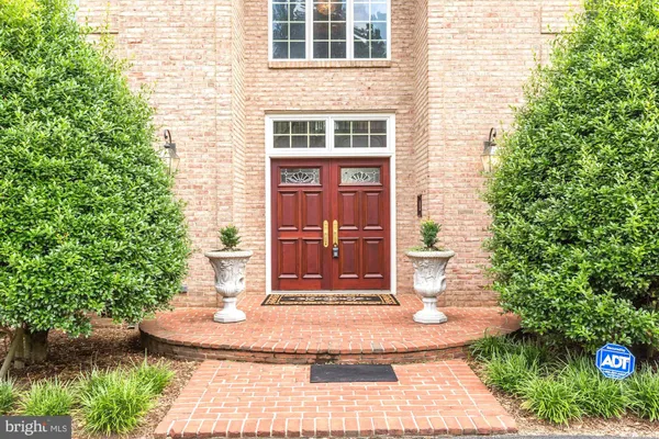 a front view of a house with a yard and trees