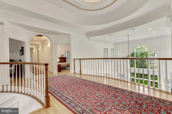 a bedroom with a rug and wooden floor