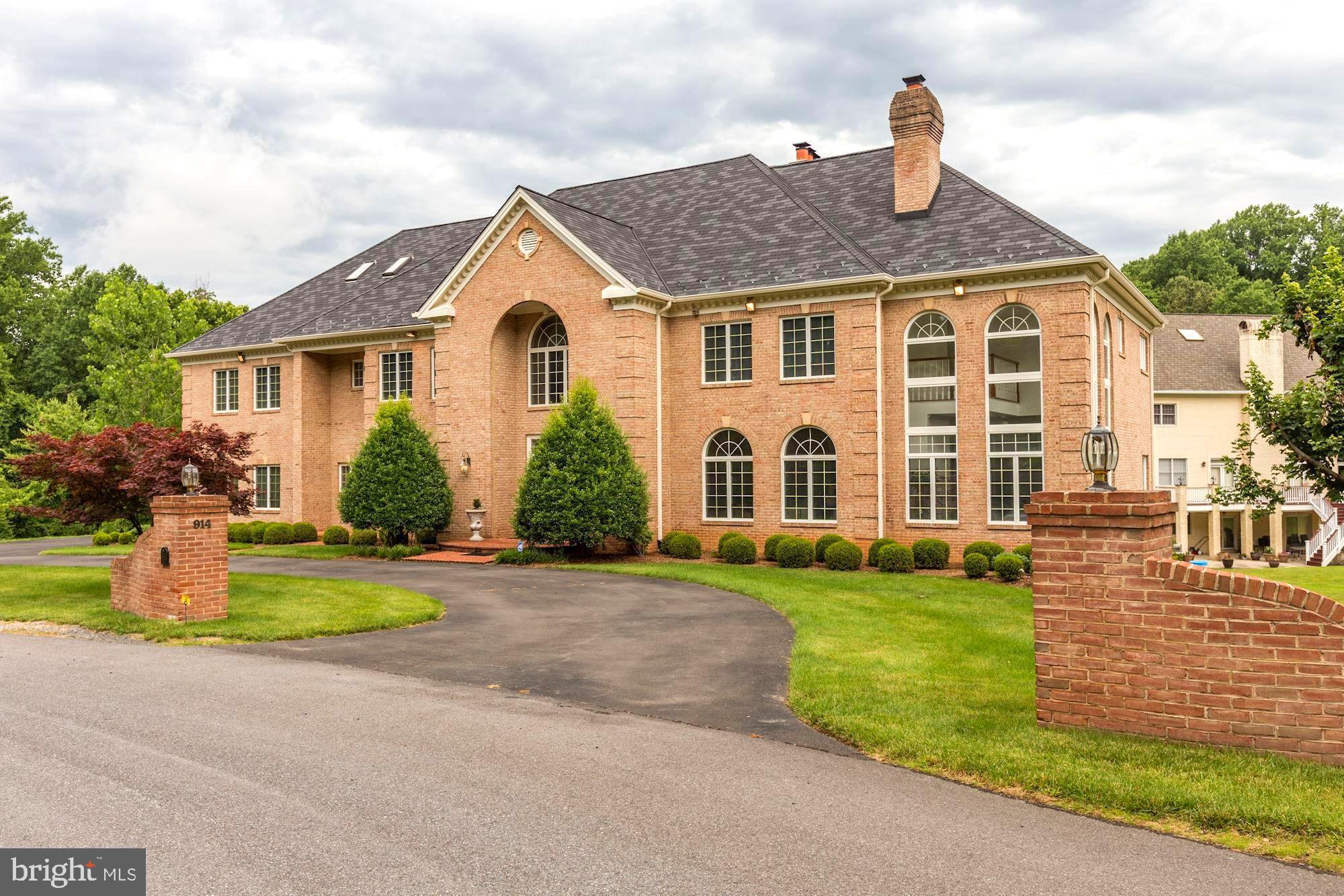 914 Helga Place McLean, VA 22102 - Photo 4 of 72 a front view of a house with a yard and garage