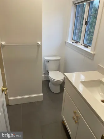 a view of a livingroom with a fireplace and window