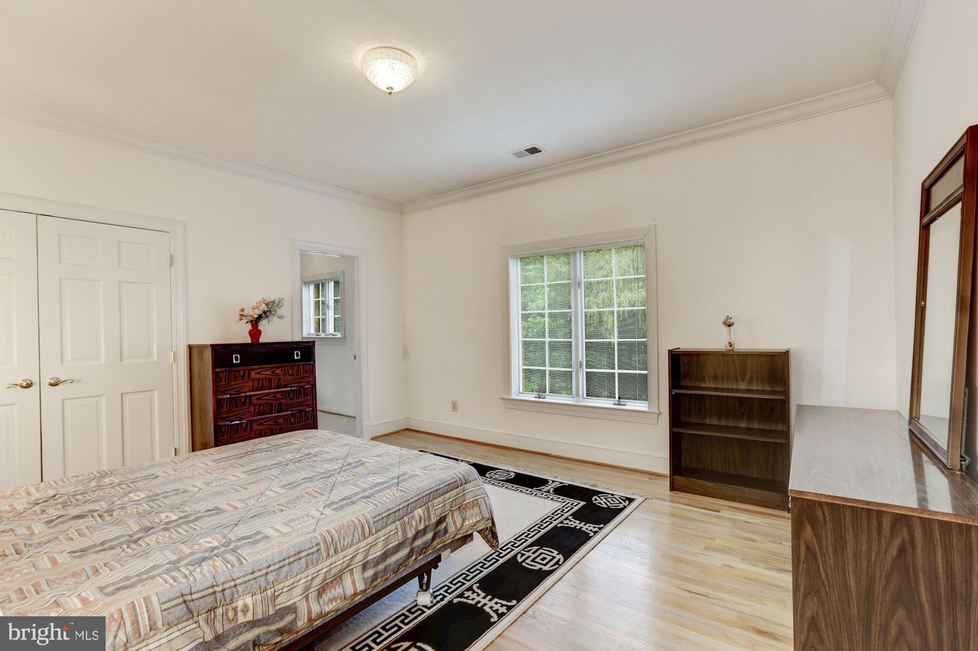 914 Helga Place McLean, VA 22102 - Photo 48 of 72 a bedroom with a bed and wooden floor