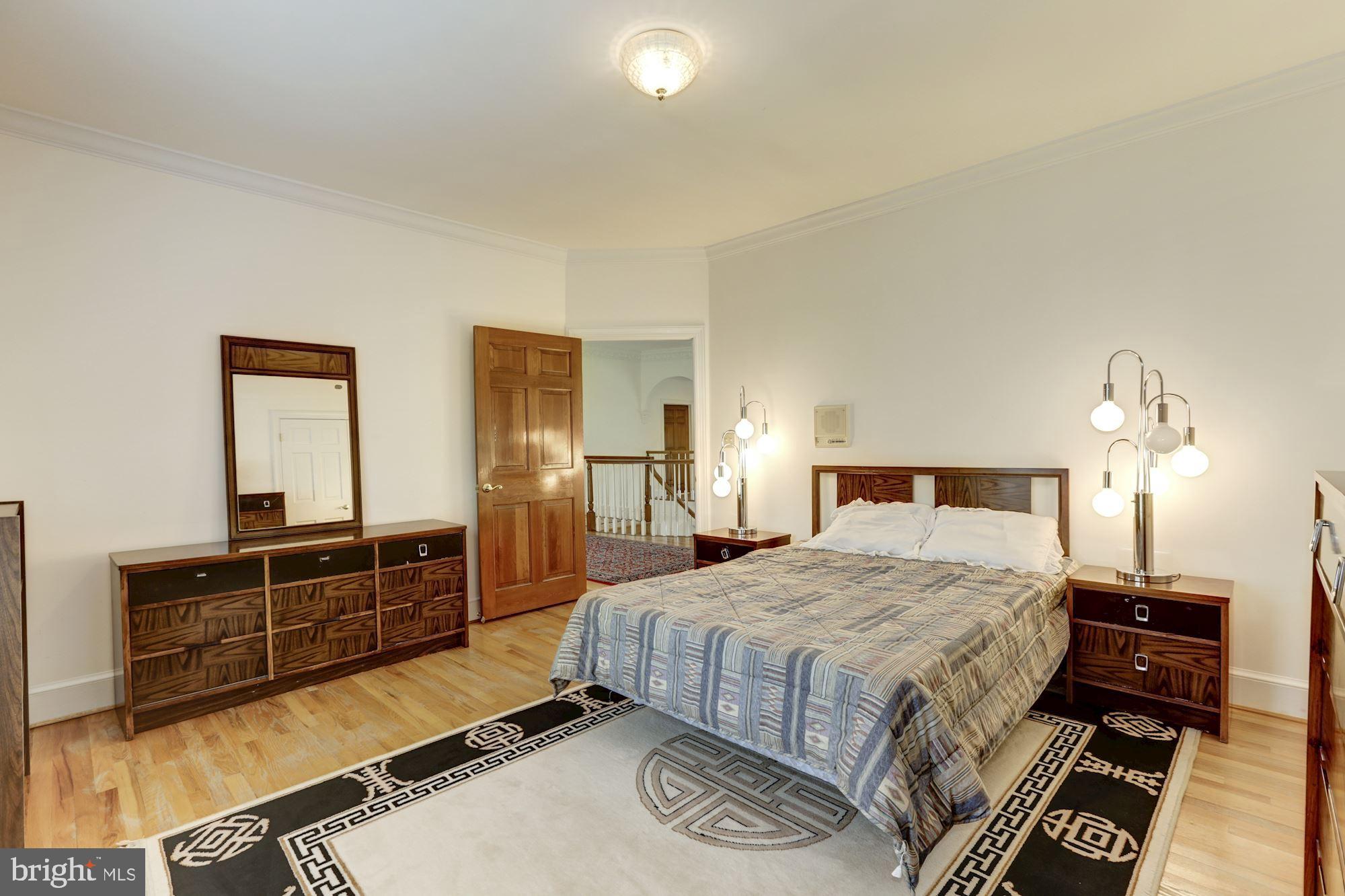 914 Helga Place McLean, VA 22102 - Photo 49 of 72 a bedroom with a bed and dresser with mirror