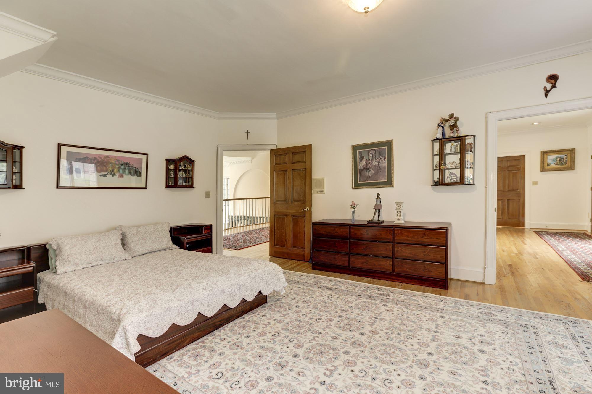 914 Helga Place McLean, VA 22102 - Photo 54 of 72 a bedroom with a bed and wooden floor