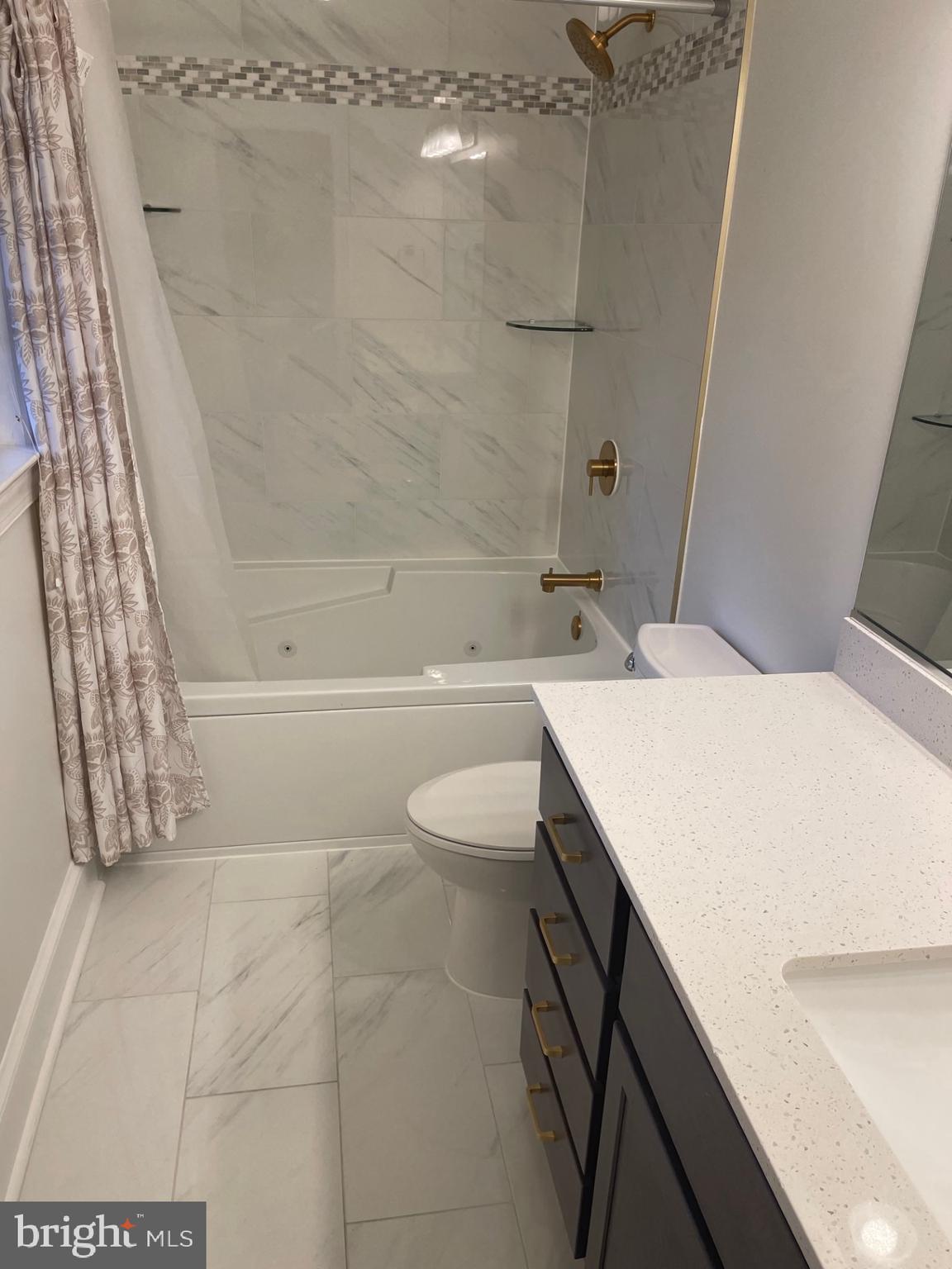 914 Helga Place McLean, VA 22102 - Photo 57 of 72 a bathroom with a sink a toilet and shower