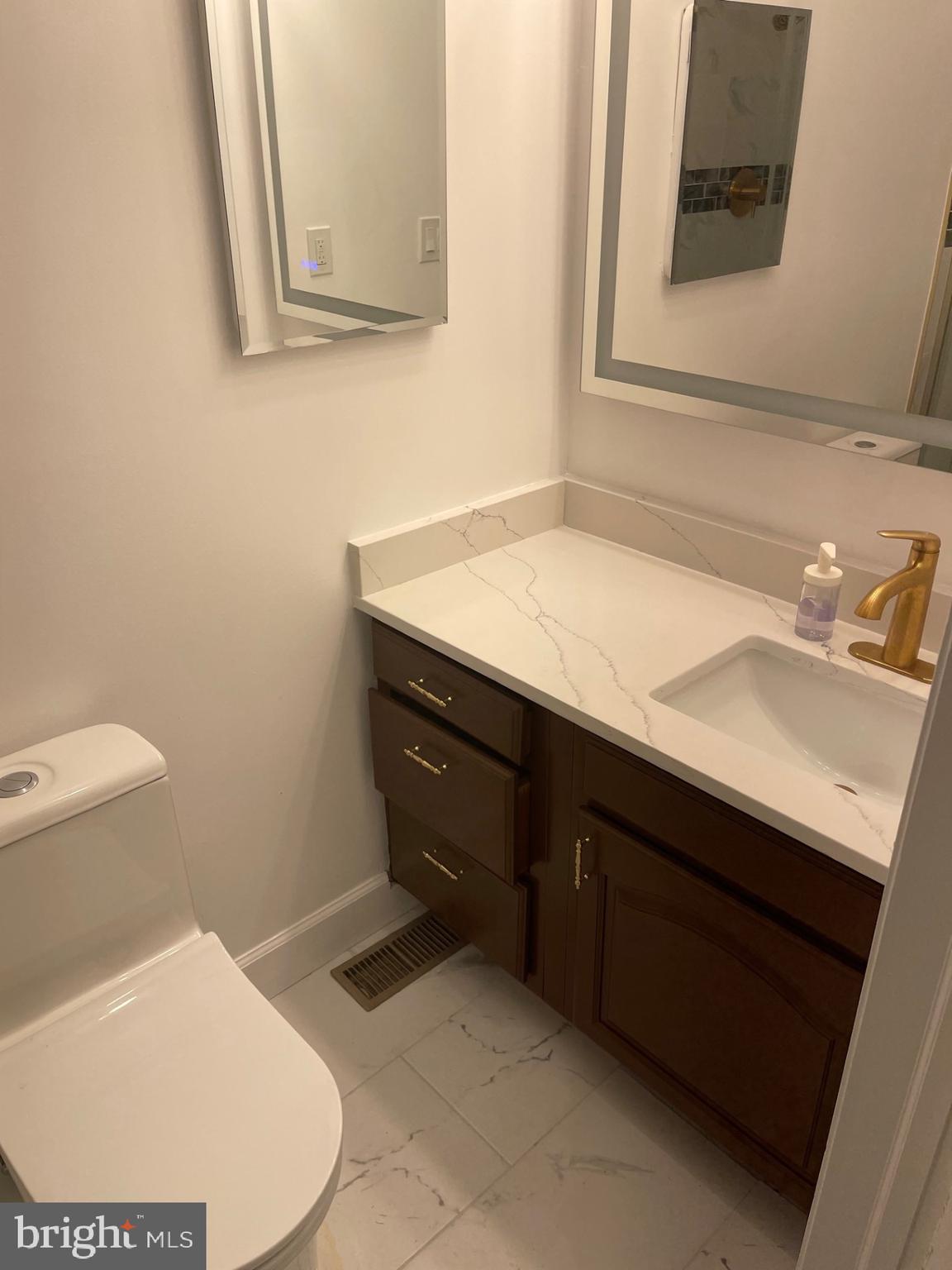 914 Helga Place McLean, VA 22102 - Photo 58 of 72 a bathroom with a sink toilet and mirror