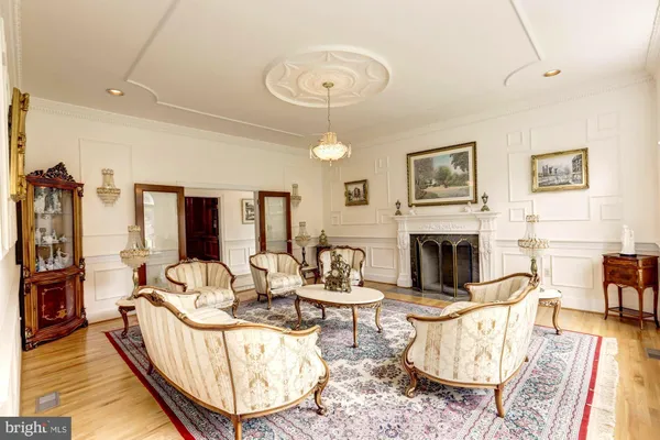 a living room with furniture a fireplace and a large window