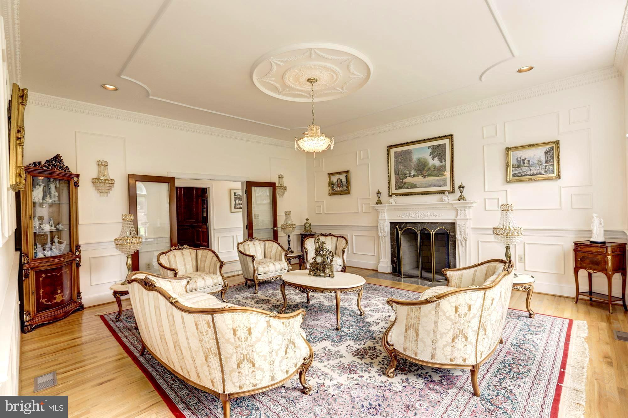 914 Helga Place McLean, VA 22102 - Photo 7 of 72 a living room with furniture a fireplace and a large window