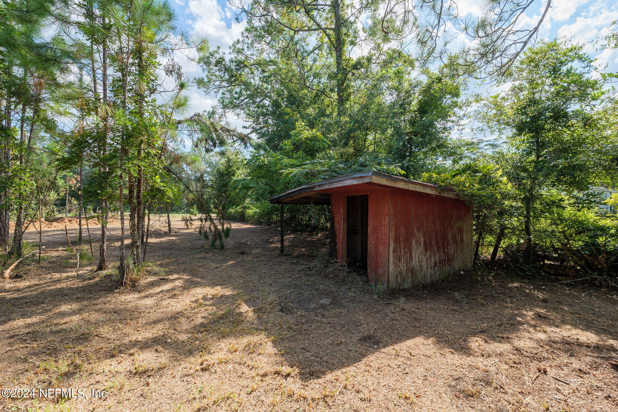 108 Howard Drive Interlachen, FL 32148 - Photo 16 of 18 a view of a barn in the middle of a yard