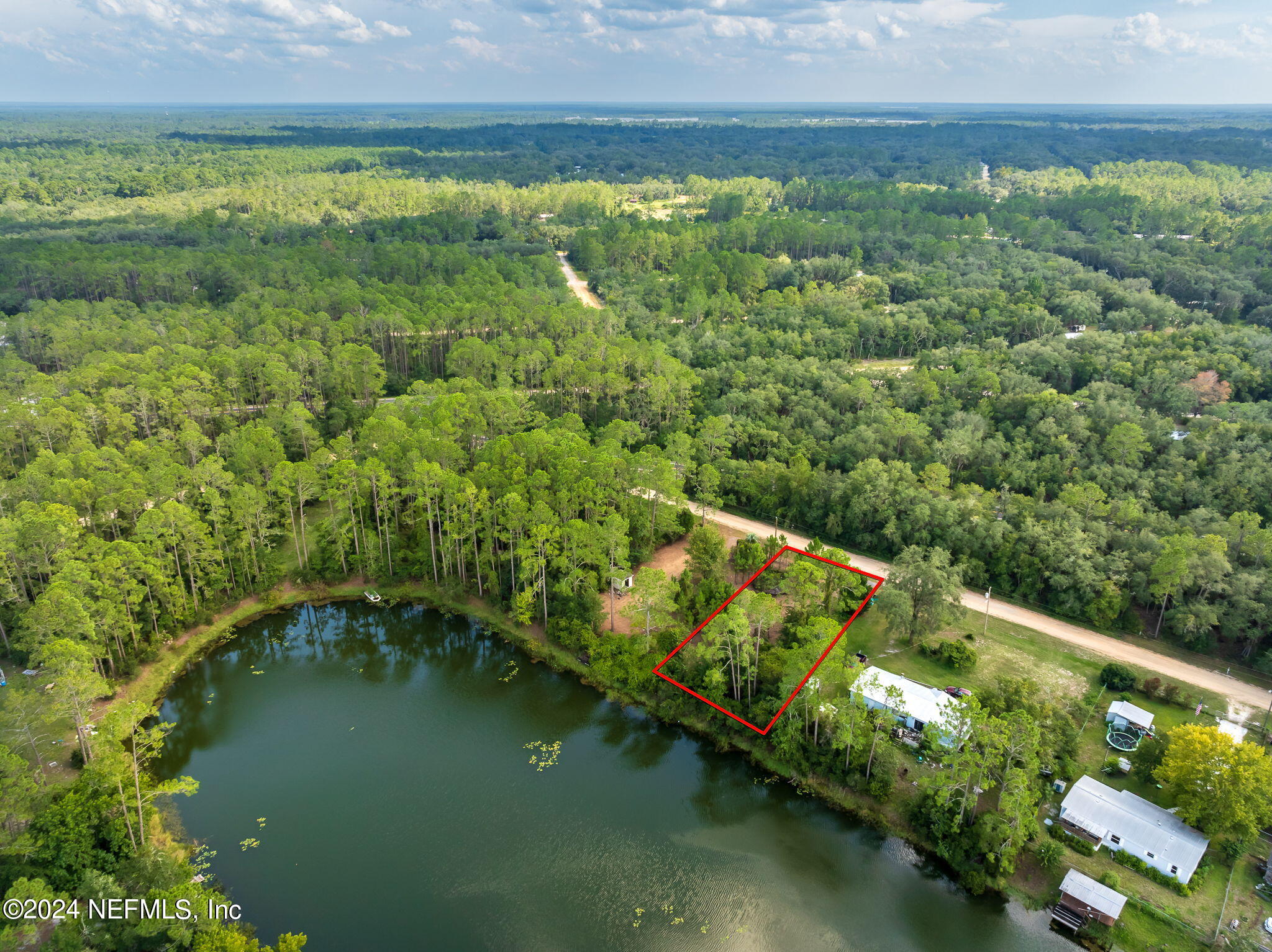 108 Howard Drive Interlachen, FL 32148 - Photo 3 of 18 a view of a lake with a yard