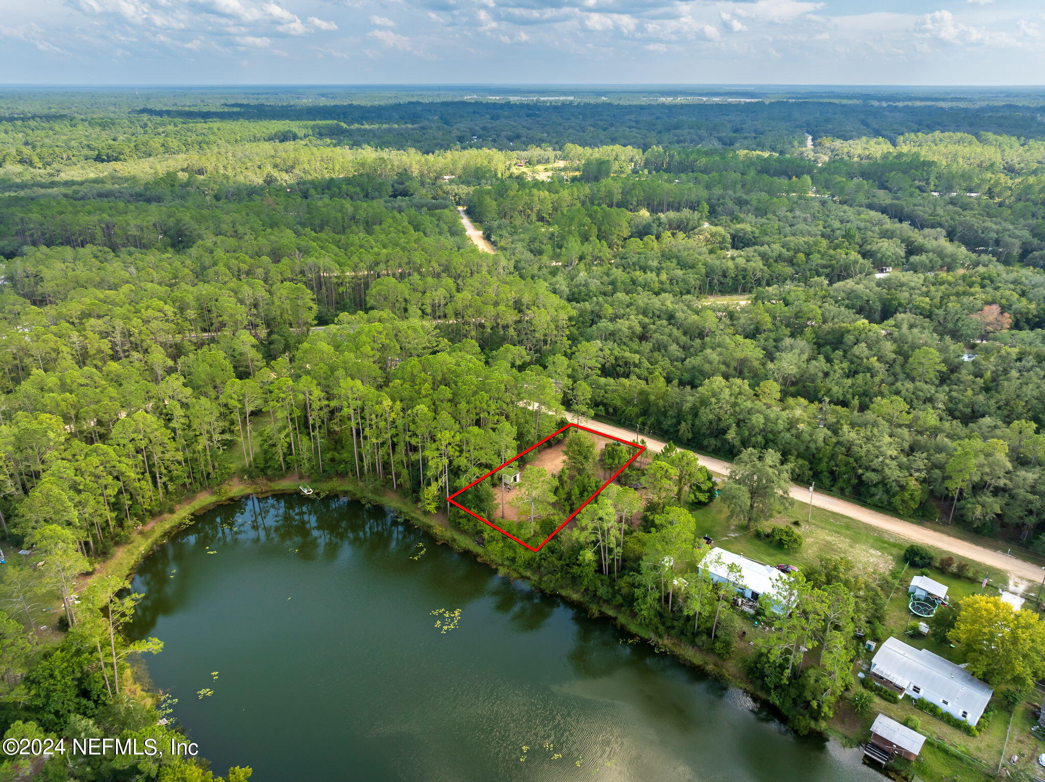 108 Howard Drive Interlachen, FL 32148 - Photo 4 of 18 a view of a lake with a yard