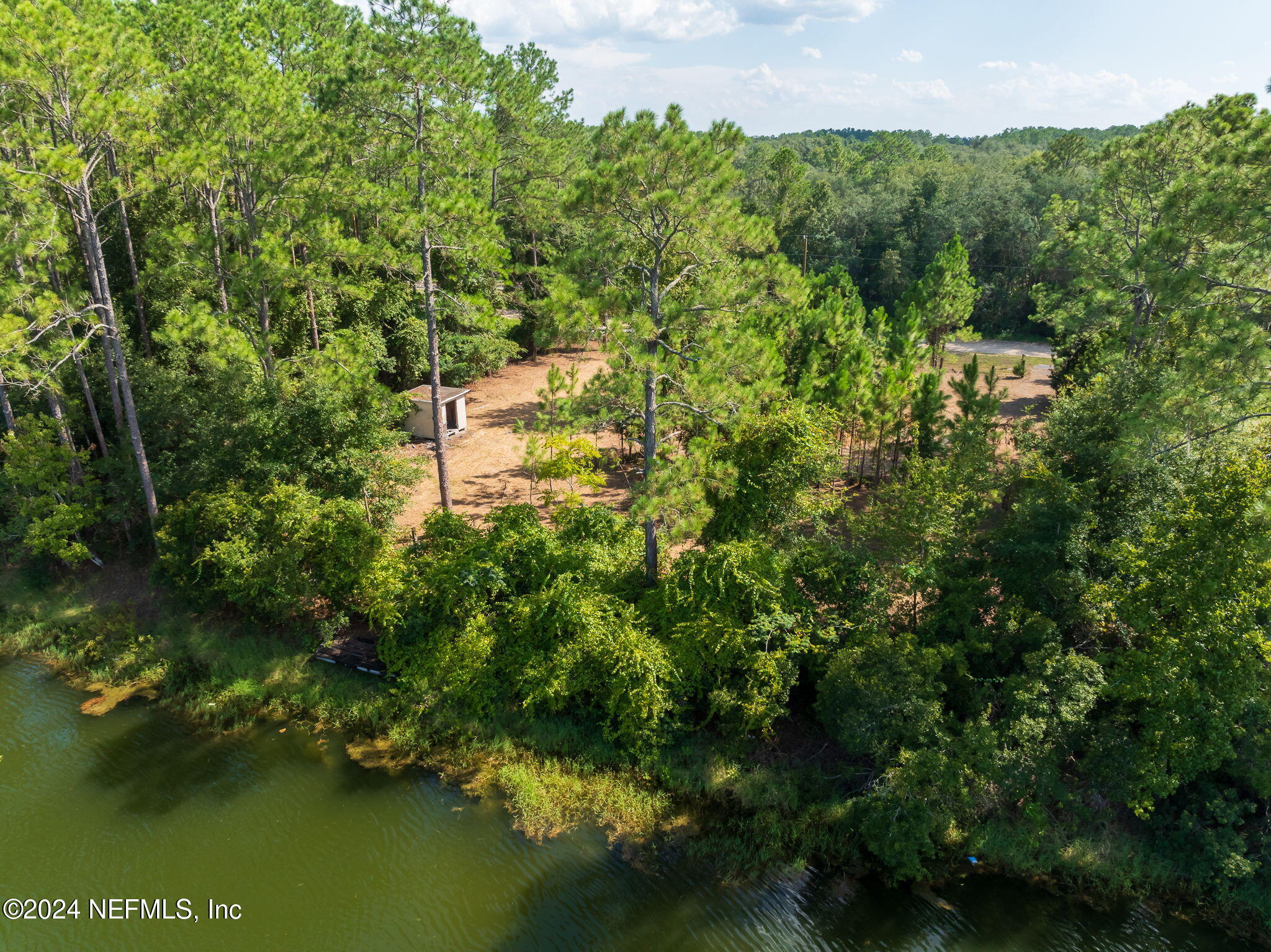 108 Howard Drive Interlachen, FL 32148 - Photo 6 of 18 a view of a lake with a building in the background