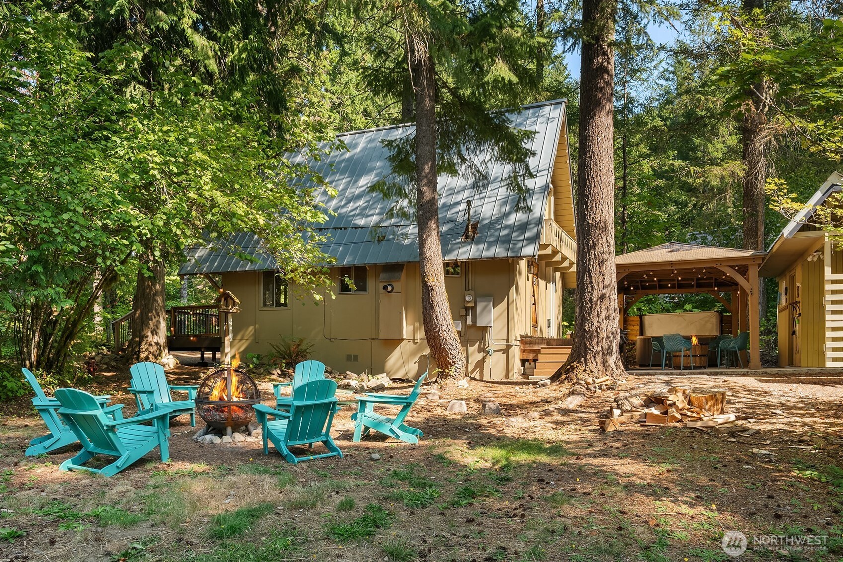 131 Timberline Drive West Packwood, WA 98361 - Photo 14 of 30 a view of a backyard with table and chairs and a large tree