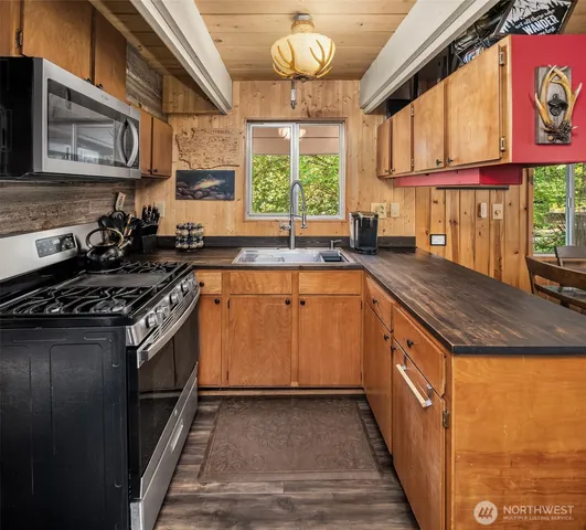 a kitchen with stainless steel appliances granite countertop a sink and a stove