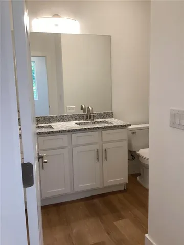 a bathroom with a sink a toilet and a mirror