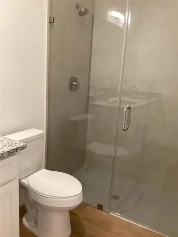 a bathroom with a toilet and a shower