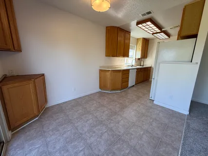 a view of kitchen with cabinets