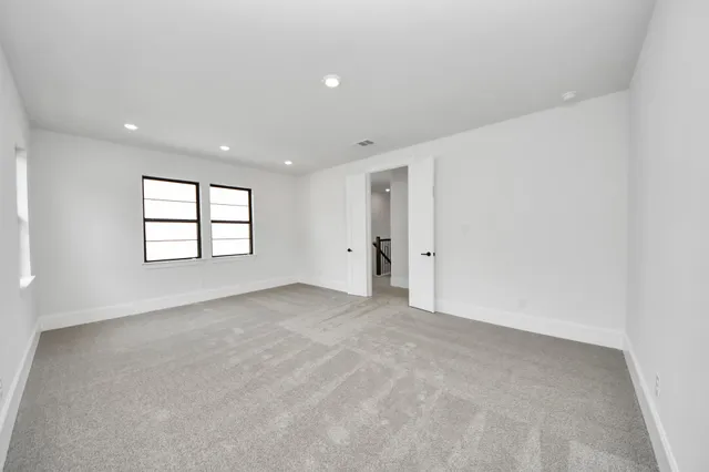 an empty room with windows and closet