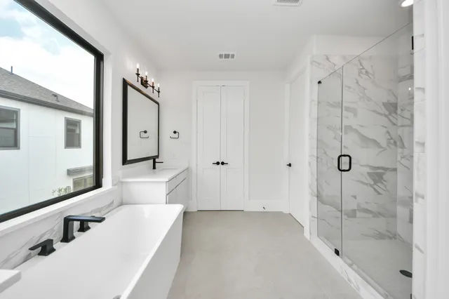 a bathroom with a tub shower and sink