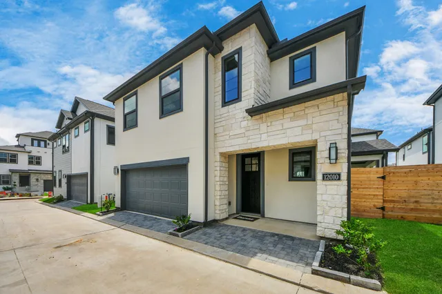 a front view of a house with garage