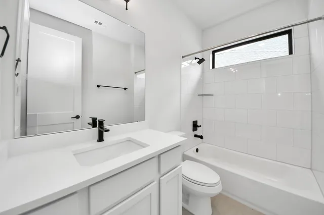 a bathroom with a sink a toilet and a shower