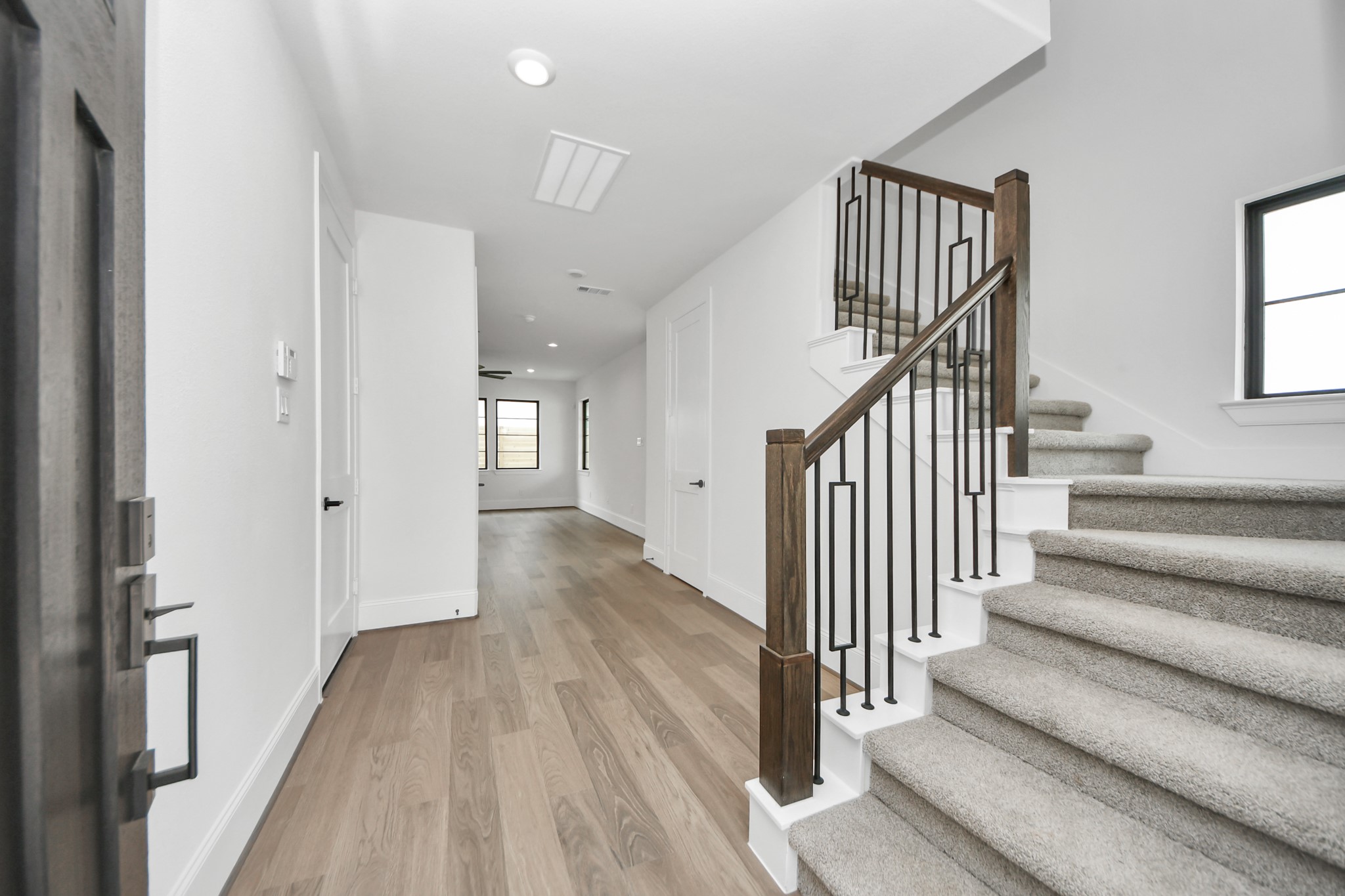 12010 Royal Oaks Banner Way Houston, TX 77082 - Photo 3 of 43 a view of a hallway with wooden floor and entryway