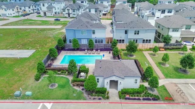a aerial view of a house with swimming pool a yard and outdoor seating