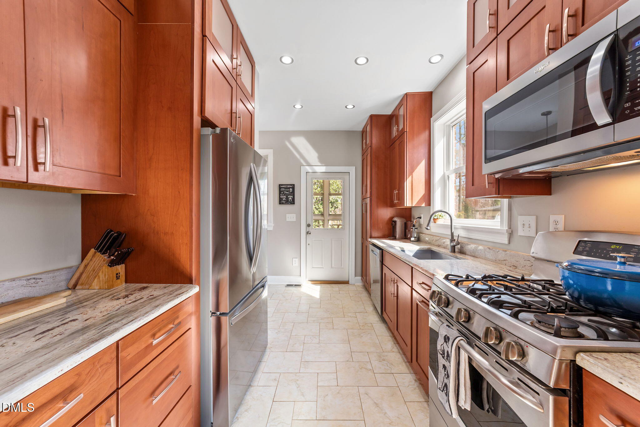3322 Ruffin Street Raleigh, NC 27607 - Photo 20 of 57 a kitchen with stainless steel appliances granite countertop a stove and a sink