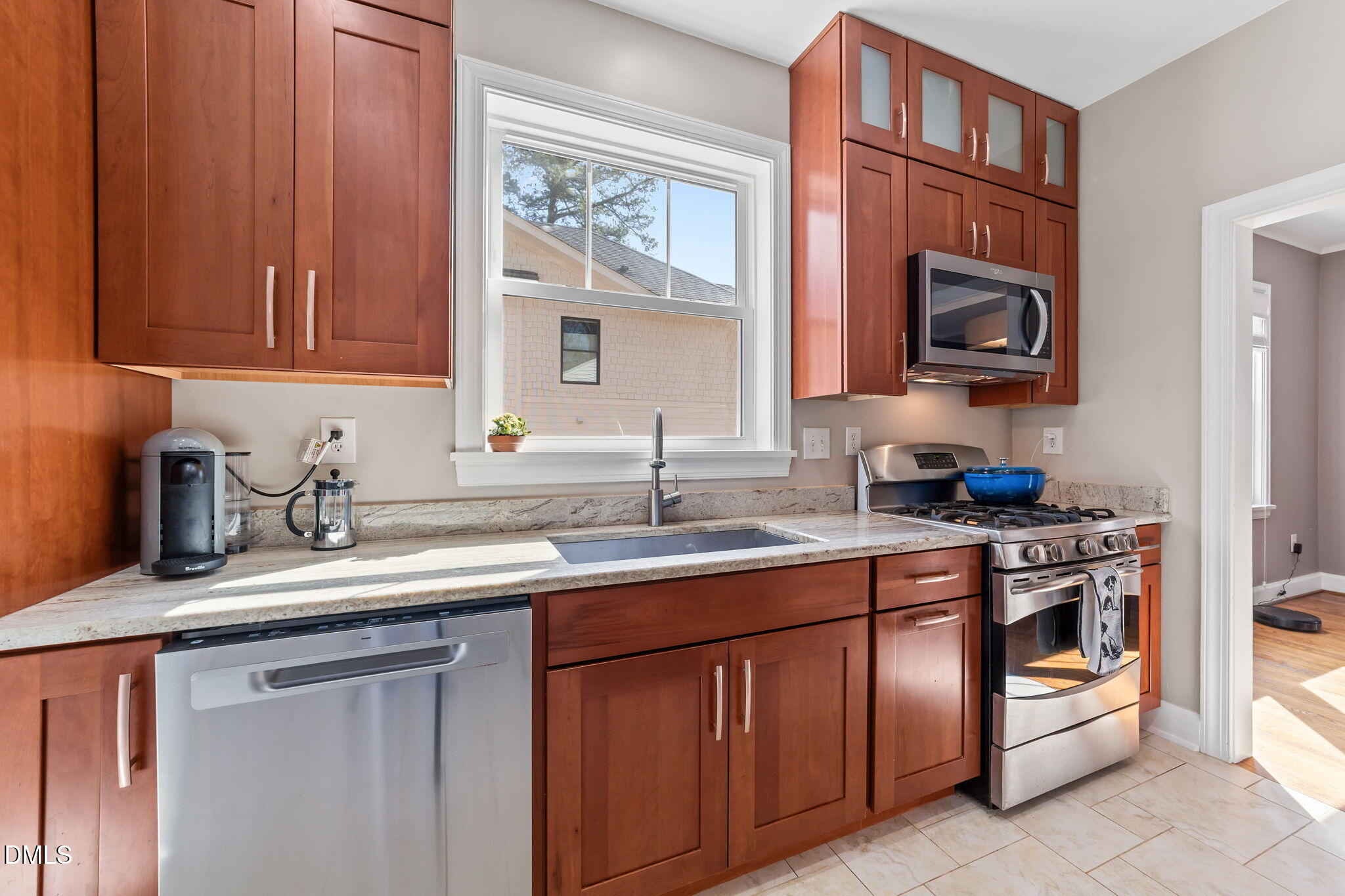 3322 Ruffin Street Raleigh, NC 27607 - Photo 21 of 57 a kitchen with stainless steel appliances granite countertop a sink stove and cabinets