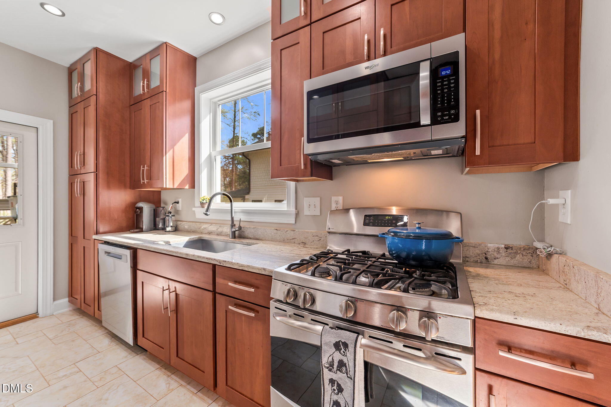 3322 Ruffin Street Raleigh, NC 27607 - Photo 23 of 57 a kitchen with stainless steel appliances granite countertop a stove and a microwave