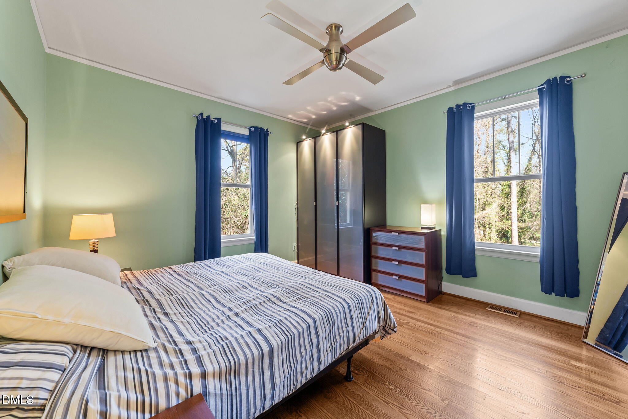 3322 Ruffin Street Raleigh, NC 27607 - Photo 36 of 57 a bedroom with a large bed and a chandelier