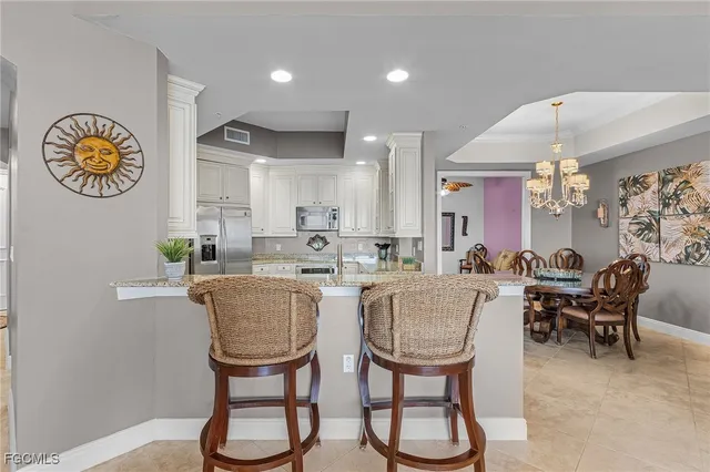 a view of a dining room with furniture a chandelier and wooden floor
