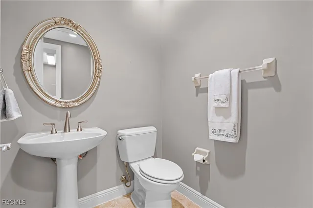 a view of a hallway with dining area and chandelier
