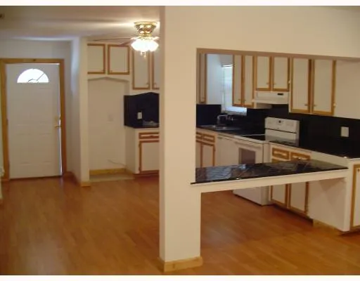 a kitchen with stainless steel appliances granite countertop a stove a sink and a granite counter tops