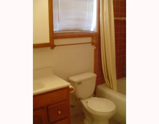 a white toilet sitting next to a blue sink