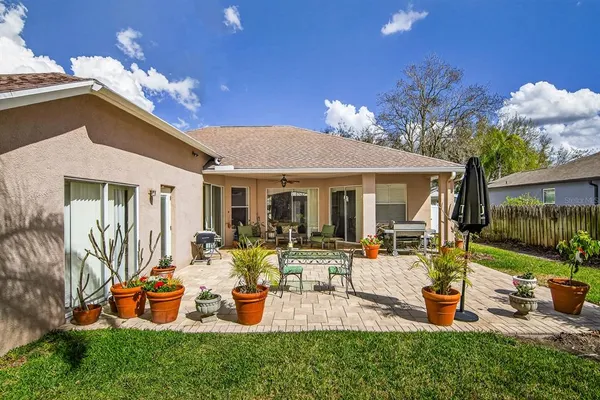 a view of a house with backyard porch and sitting area