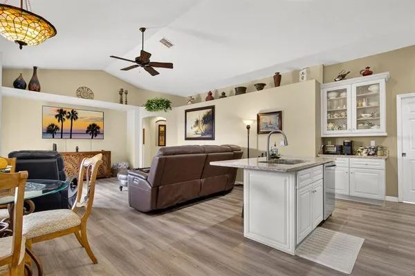 a living room with kitchen island furniture and a fireplace