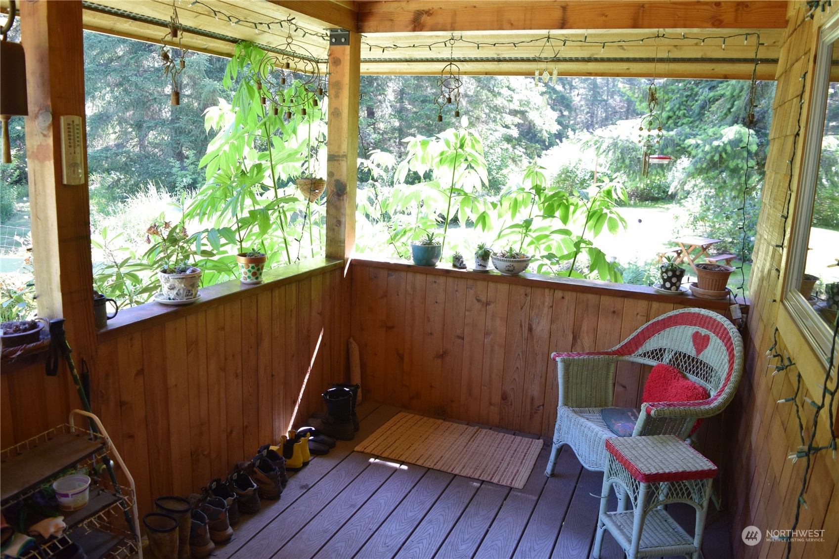 124 Larson Lake Road Chimacum, WA 98325 - Photo 3 of 39 a view of a balcony with furniture and wooden floor