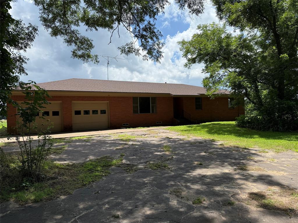 503 County Rd SE 4380 Scroggins, TX 75480 - Photo 11 of 40 a front view of a house with a yard and garage