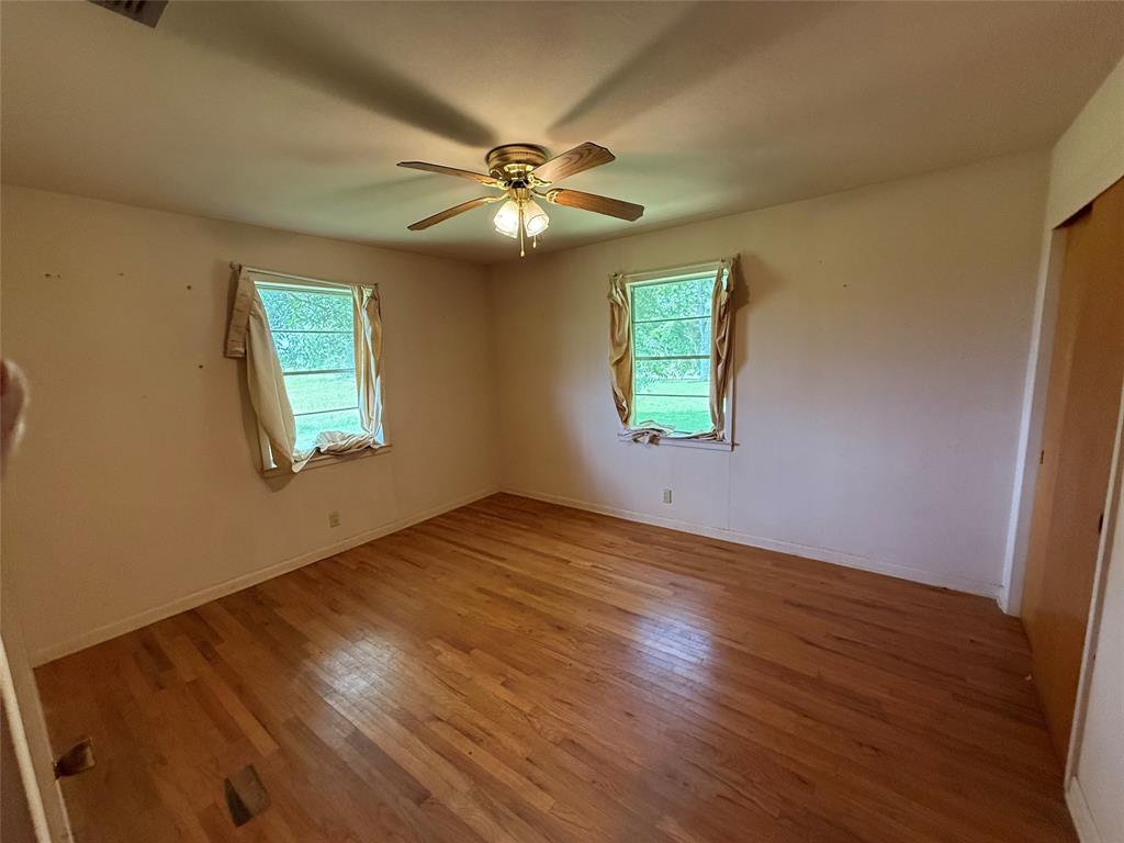 503 County Rd SE 4380 Scroggins, TX 75480 - Photo 16 of 40 a view of an empty room with wooden floor and a window