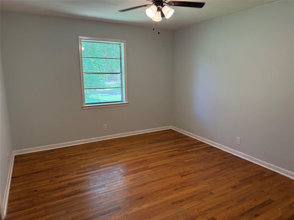 503 County Rd SE 4380 Scroggins, TX 75480 - Photo 19 of 40 a view of an empty room with wooden floor and a window