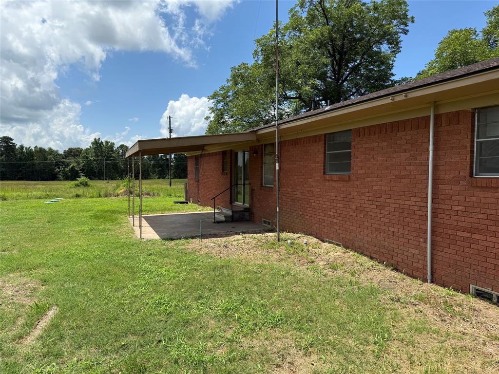 503 County Rd SE 4380 Scroggins, TX 75480 - Photo 25 of 40 a view of a backyard with a garden and entertaining space