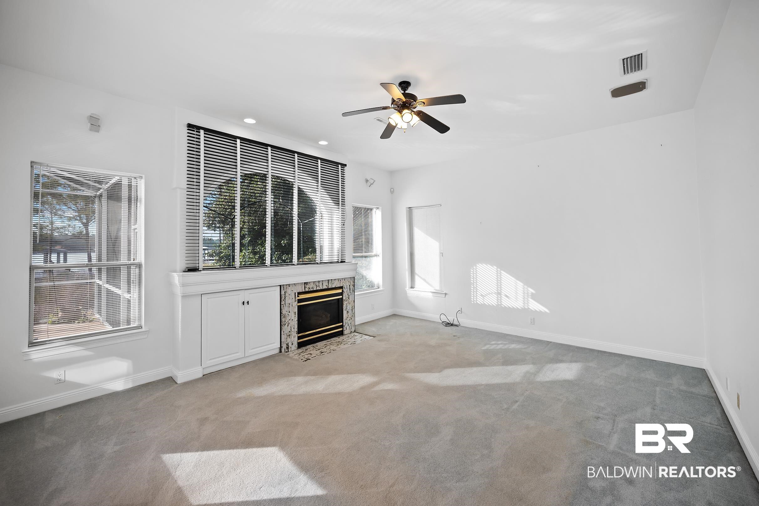 8591 Bay Harbor Road Elberta, AL 36530 - Photo 16 of 56 Unfurnished living room featuring light colored carpet, a high end fireplace, ceiling fan, and recessed lighting