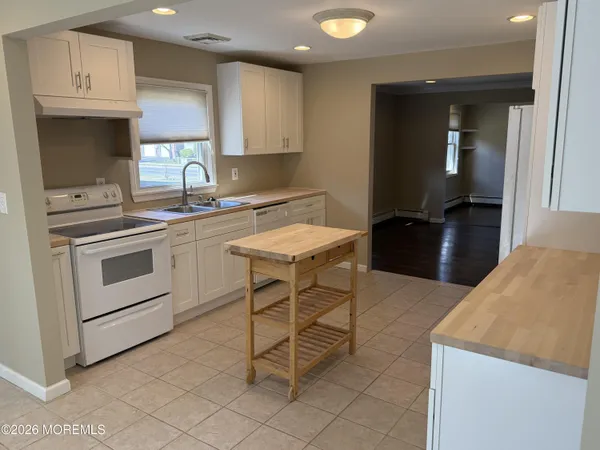 a kitchen with a stove a sink and a refrigerator